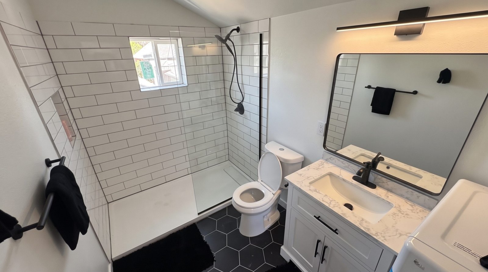Modern walk-in glass shower and upscale bathroom finishes in a Denver garage ADU rental
