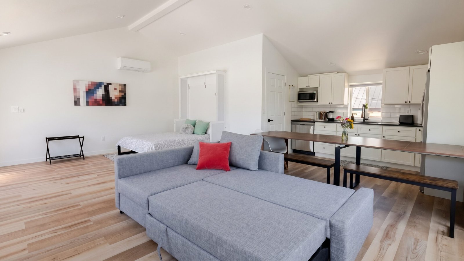Bright open-concept living area with comfortable sofa in a Sunnyside Denver garage ADU rental