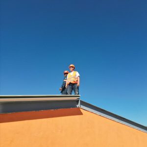A man standing on top of a skateboard ramp