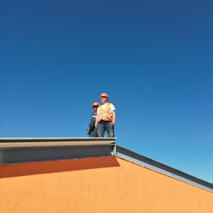 A man standing on top of a skateboard ramp