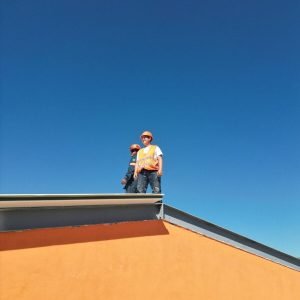 A man standing on top of a skateboard ramp